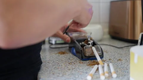 Creating Cigarettes at Your Own Residence with the Use of a Tobacco Rolling Stock Footage 304684342