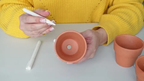 Creating with clay pots: Methods of painting by a marker for creative home decor Stock Footage 306643180
