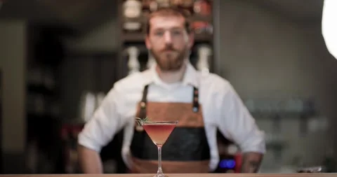 Creating a cocktail at a bar with a skilled barman, showcasing the process and Stock Footage 323405592
