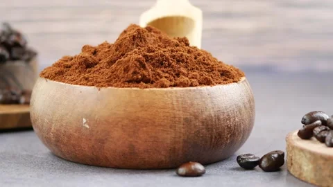 Creating coffee grounds and whole beans in a kitchen setting Stock Footage 345474271