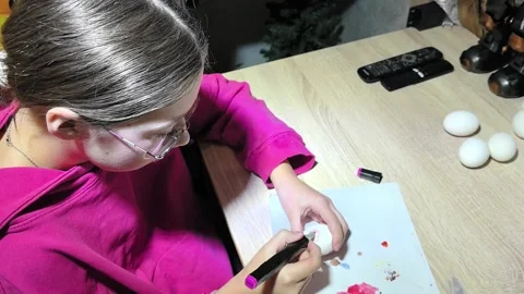 Creating colorful designs on eggs at home during spring crafting session Stock Footage 328438751