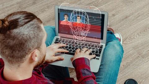 Creating deep fake content on a laptop in a home setting with a focus on video 写真素材