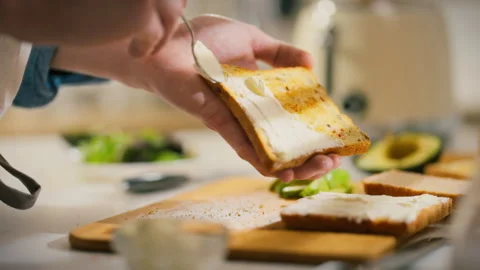 Creating a delicious breakfast spread with toasted bread and fresh ingredien Stock Footage 305338511