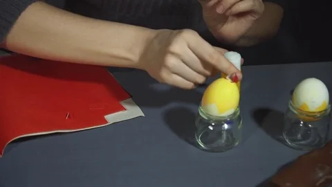 Creating easter chicken from the shell by hand on a grey table. Stock Footage 73148785