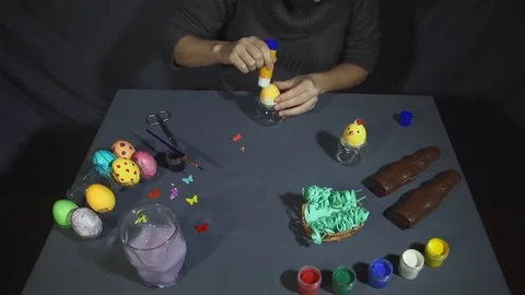 Creating easter chicken from the shell by hand on a grey table. Stock Footage 73149343