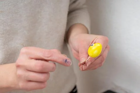 Creating Easter fun personified yellow egg decoration at home Stock Photos