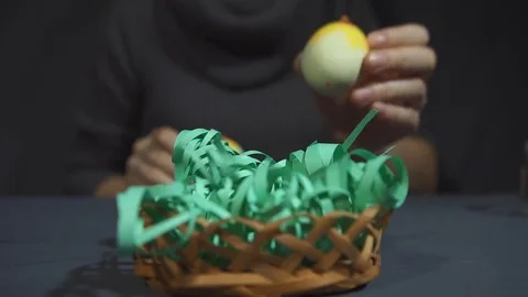Creating easter souvenir from chicks of eggshells by hand on a grey table. Stock Footage 73149738