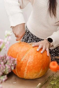 Creating a floral composition in a pumpkin. Making decor with your own hands. Stock Photos