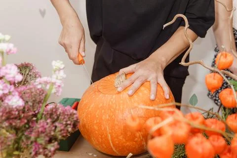 Creating a floral composition in a pumpkin. Making decor with your own hands. Stock Photos