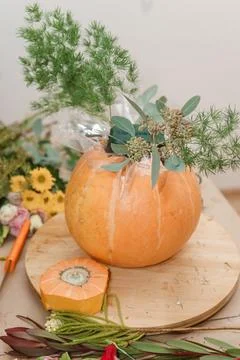 Creating a floral composition in a pumpkin. Making decor with your own hands. Stock Photos