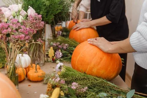 Creating a floral composition in a pumpkin. Making decor with your own hands. Stock Photos