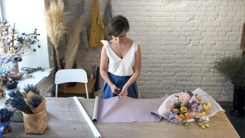 Creating flower bouquet in workshop.. Stock Photos