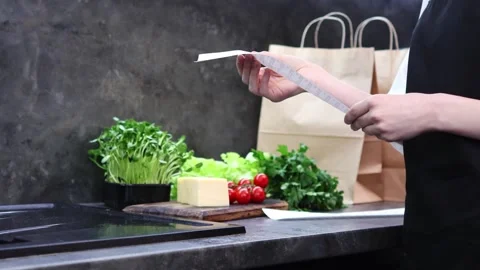 Creating a fresh culinary masterpiece with vibrant ingredients and a recipe Stock-Footage 296315954
