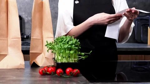 Creating fresh meals using local produce in a cozy kitchen setting Stock-Footage 296315556