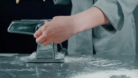 Creating Fresh Pasta Using a Traditional Pasta Machine for Perfect Culinary Stock Footage 313750129