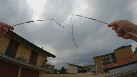 Creating giant soap bubbles in backyard with long sticks Stock Footage 279890315