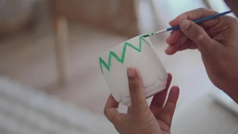 Creating a hand-painted pot with colorful designs Stock Footage 339519183