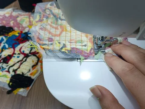 Creating a handmade textile artwork with a sewing machine. Stock Photos