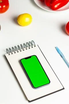 Creating healthy eating plan on smartphone. Nutrition plan. Green screen 스톡 사진