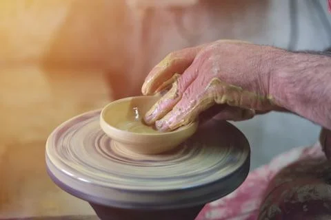 Creating a jar or vase of white clay close-up. Man hands, pottery, workshop,  Stock Photos