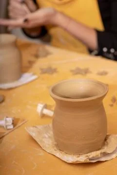 Creating a jar or vase of white clay close-up. Twisted potter's wheel. Stock Photos