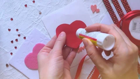 Creating love card with red heart on valentine's day Stock Footage 146860421