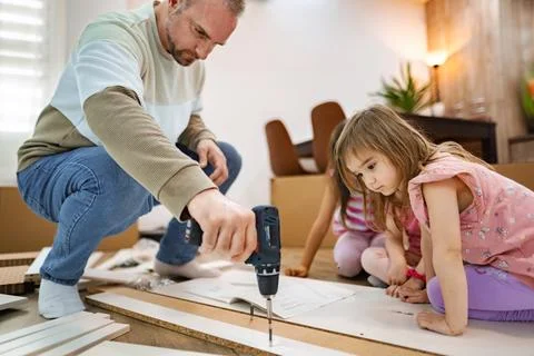 Creating memories while assembling furniture together Stock Photos