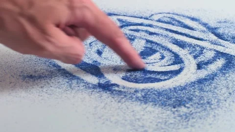 Creating patterns with glitter for crafts in a bright workspace Stock Footage 338406274
