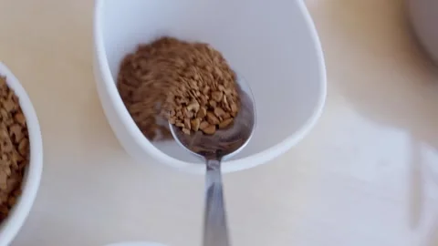 Creating perfect cup of coffee with sugar and a spoon in a cozy kitchen setting 库存影片 329435197