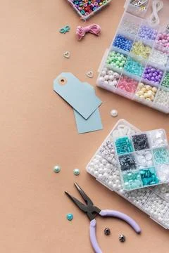 Creating personalized crafts with beads and tags on a light background for .. Stock Photos