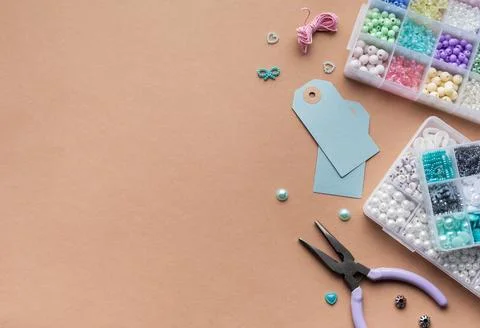 Creating personalized crafts with beads and tags on a light background for .. Stock Photos