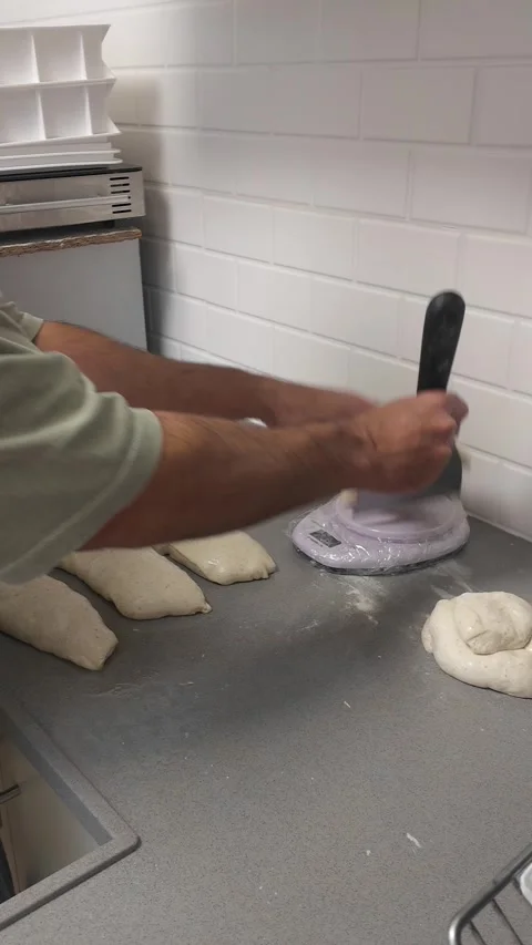 Creating pizza balls from Caputo 00 dough in bakery setting, vertical timelapse Stock Footage 322194991