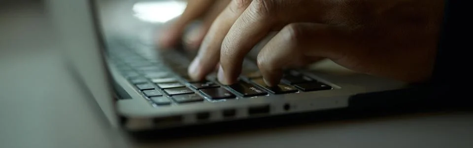 Creating process. Close up shot of hands of young guy typing, working on laptop 스톡 사진