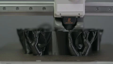 Creating a prototype on a 3D printer. Printing with plastic on a 3D printer Stock Footage 303469289