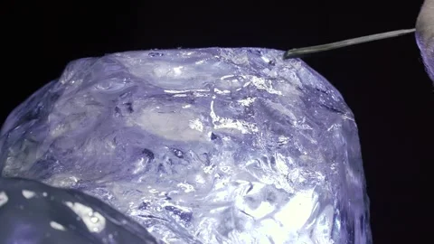 Creating a sculpture out of ice, ice flakes are flying while artist working, 4k Stock Footage 153587133