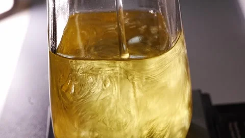 Creating shimmering golden aroma diffuser liquid Stockbeeldmateriaal 336558307