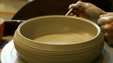 Creating a simple pattern on a clay cup blank on a potter's wheel Video stock 165550959