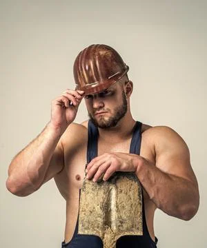 Creating solid foundation. athletic builder in helmet. sexy man with shovel Stock Photos
