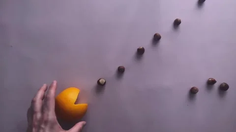 Creating a stop motion video of Pacman devouring fruits diagonally Stock Footage 262232385