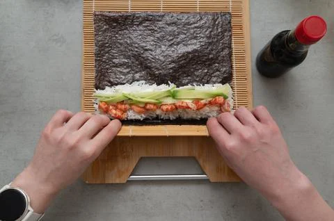 Creating Sushi Rolls Using Fresh and Quality Ingredients for a Delectable Stock Photos