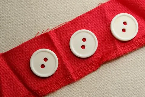 Creating unique designs with red fabric and classic buttons Stock-Fotos