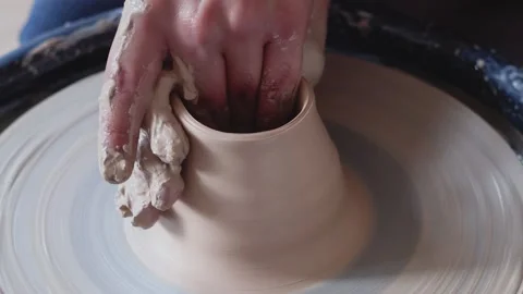 Creating vase of white clay close-up. The sculptor in workshop makes jug out of Stock-Footage 143614990