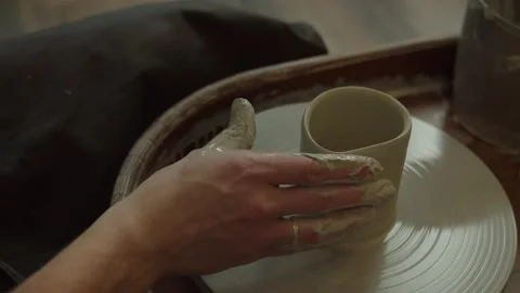 Creating vase of white clay close-up. The sculptor in workshop makes jug out of  Video stock 236202410