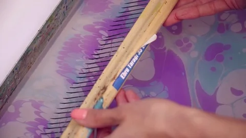 Creating violet painting using the ebru technique Stock Footage 74719851