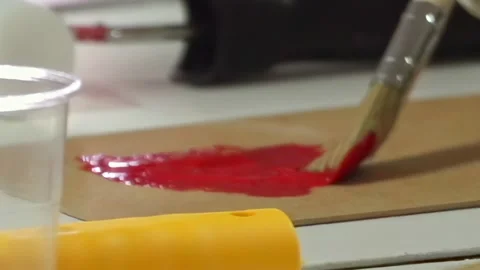 Creating Vivid Red Strokes With a Brush in an Inspiring Art Moment Stock Footage 340594377