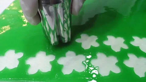 Creating White 3D Jelly Flowers Inside Green Gelatin Art Cake Close Up Stock Footage 345292146