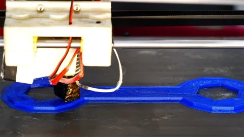 Creating a wrench-shaped product on a 3D printer Stock Footage 147869466