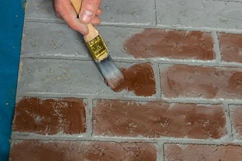 Creation of artificial bricks, the process of painting a photographic background Stock Photos