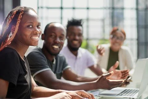 Creation of a new application in a team. young programmers sit at the table Stock Photos