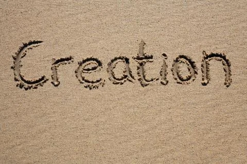 Creation, written on a sandy beach. Stockfoto's